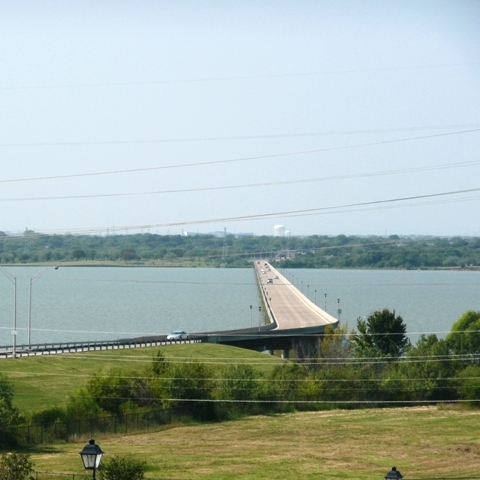 The Mountain Creek Lake Bridge (MCLB) is located in southwest Dallas and crosses Mountain Creek Lake providing connection to Spur 303 on either side. The total length of the MCLB is approximately two miles. The MCLB was opened on April 30, 1979.